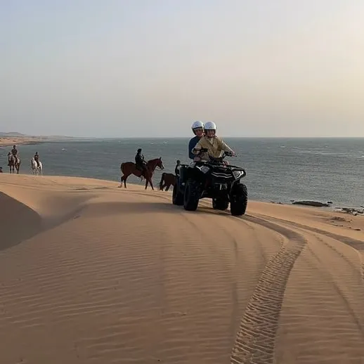 Horseback riders on the beach south of Diabat