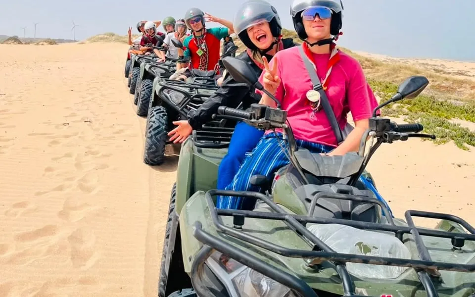 Group of riders on quad bikes crossing the sand dunes near Essaouira, Morocco