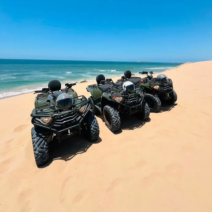 Quads lined up above the turquoise shallows